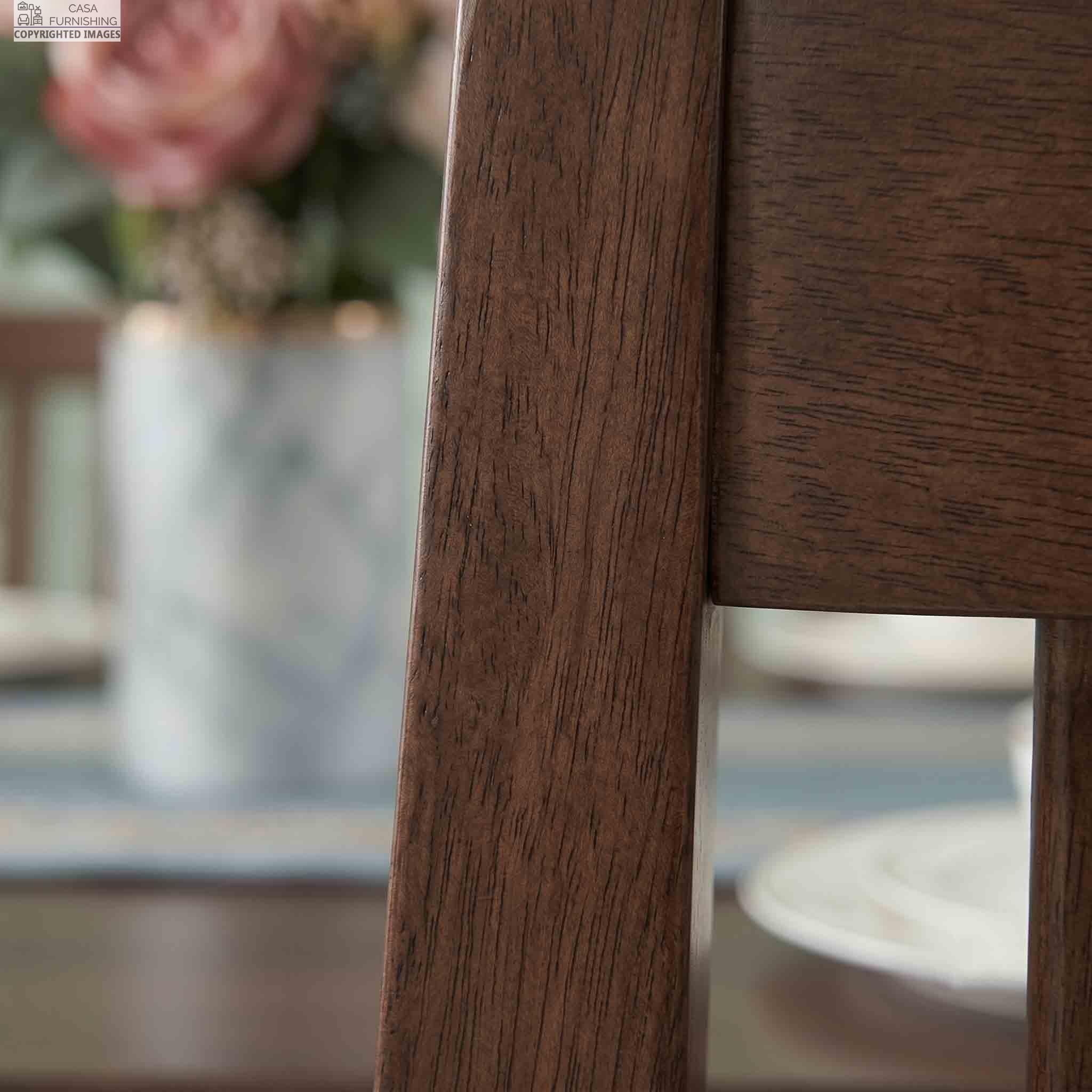 Close-Up Premium Solid Wood Grain Texture - High-Quality Sheesham Wood Furniture Finish Detail Close-up detail of the smooth finish and natural grain patterns on a premium handcrafted Sheesham solid wood dining chair frame.