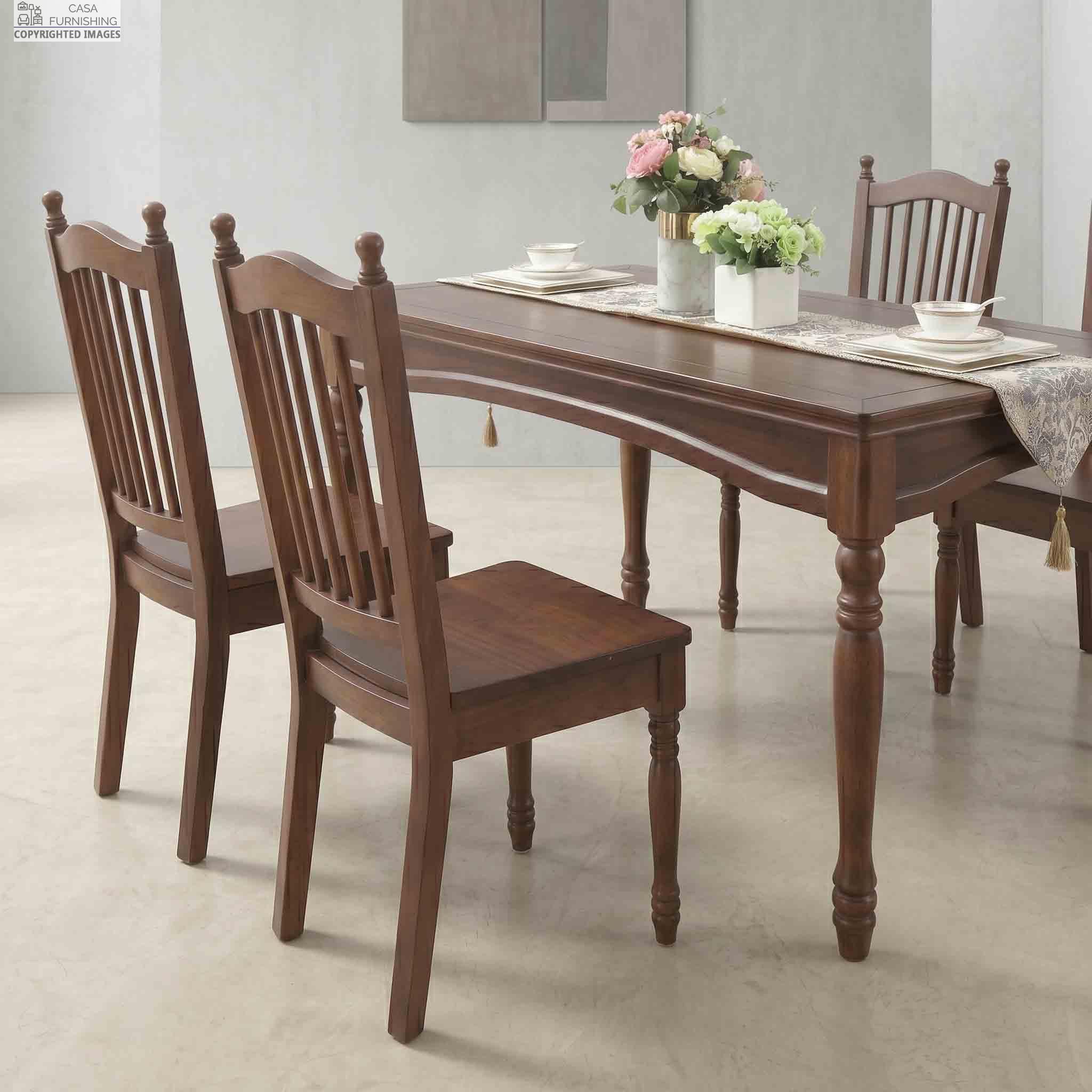 High-Back-Wooden-Dining-Chairs-with-Spindle-Design-Set-of-4 Close-up perspective view of a Casa Furnishing premium solid wood dining table set, showcasing elegant vertical slatted-back wooden chairs and a polished rectangular table adorned with a classic tasseled runner and floral centerpieces.