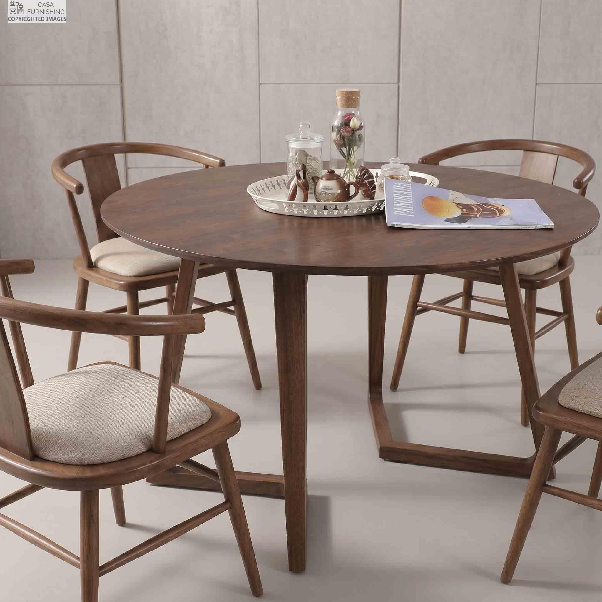 Minimalist-4-Seater-Round-Wooden-Dining-Table-Set-for-Home Elegant solid wood round dining table with unique intersecting geometric leg base and matching modern wooden dining chairs.