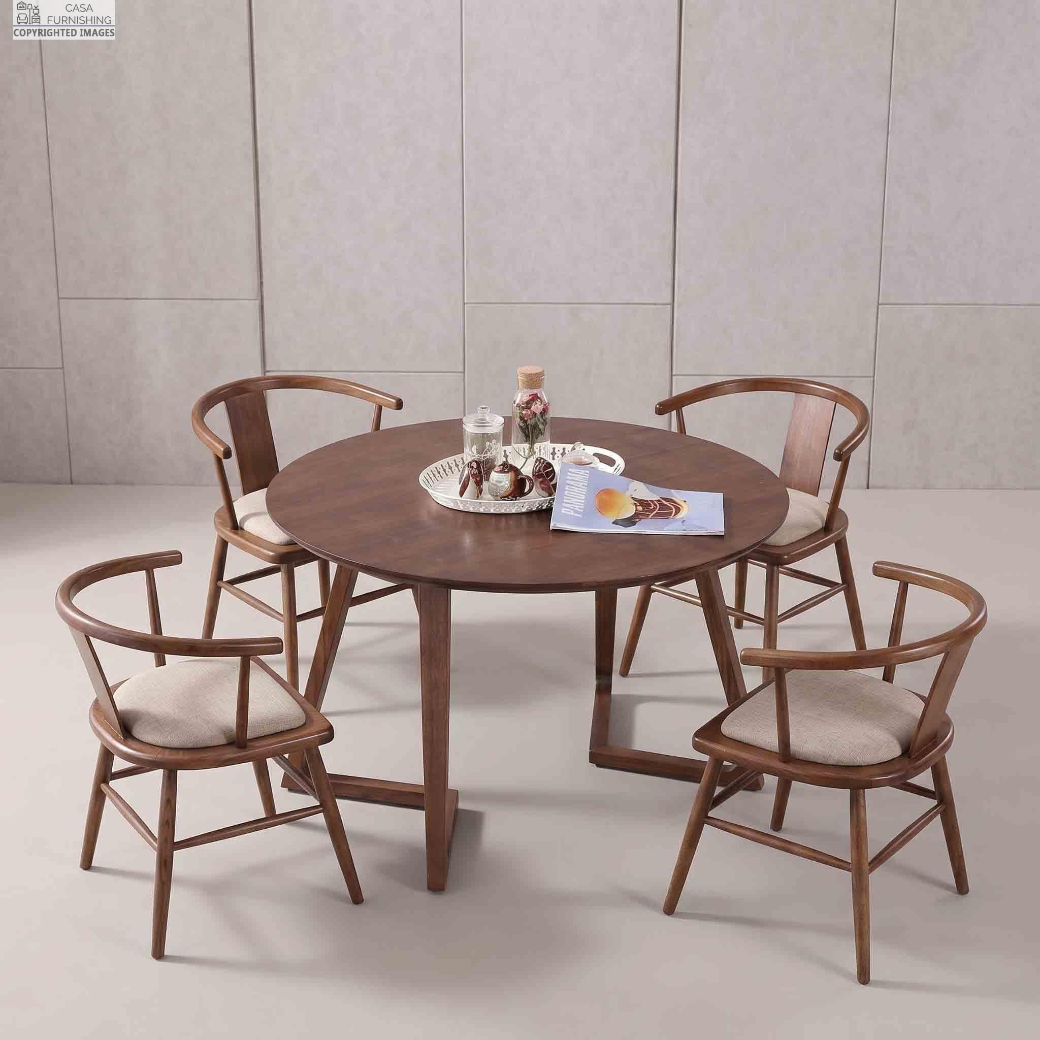 Modern-Round-Wooden-Dining-Table-with-Upholstered-Chairs Modern minimalist dining room setting featuring a 4-seater round solid wood dining table and comfortable upholstered wooden chairs.