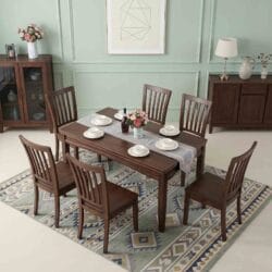 Contemporary dark wood rectangular dining table and six matching solid wood chairs set against a minimalist green accent wall.