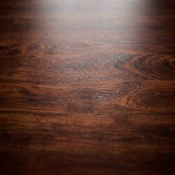 Macro texture shot showcasing the rich natural grain patterns and dark polished finish of a premium Sheesham solid wood tabletop.