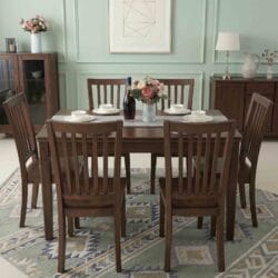 Front view of a luxury dark walnut finish solid wood 6-seater dining table set with elegant slatted chairs and tabletop decor.