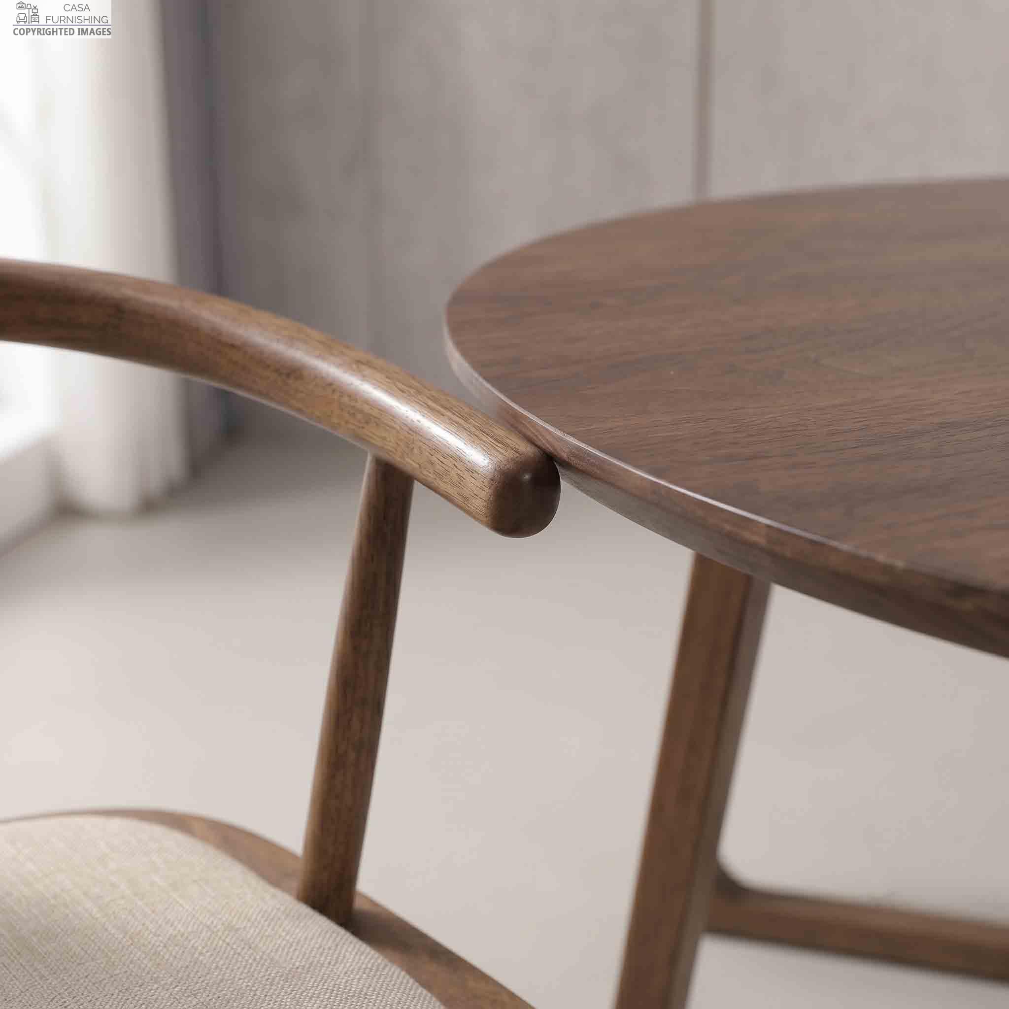 Premium-Wooden-Dining-Chair-Armrest-and-Table-Edge-Detail Close-up detail of the smooth polished finish, curved armrest, and fine joinery on a premium wooden dining chair and table.