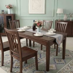 Casa Furnishing premium 6-seater solid wood dining table set with classic slatted-back wooden chairs in a beautifully styled dining room.
