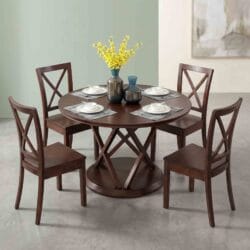 Elegant round wooden dining table showcasing an intricate geometric interlocking pedestal base, surrounded by four classic X-back dining chairs.