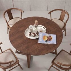 High-angle view of a luxury round solid wood dining table set with four matching cushioned wooden dining chairs.