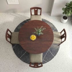 Birds-eye view of a 4-seater round wooden dining table set highlighting the symmetrical seating arrangement and rich wood finish.