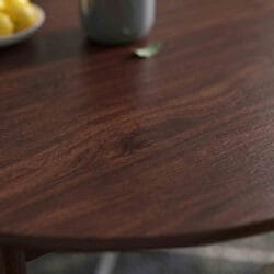 Macro texture shot showcasing the durable polished surface and rich dark wood grain of a Casa Furnishing solid wood tabletop.