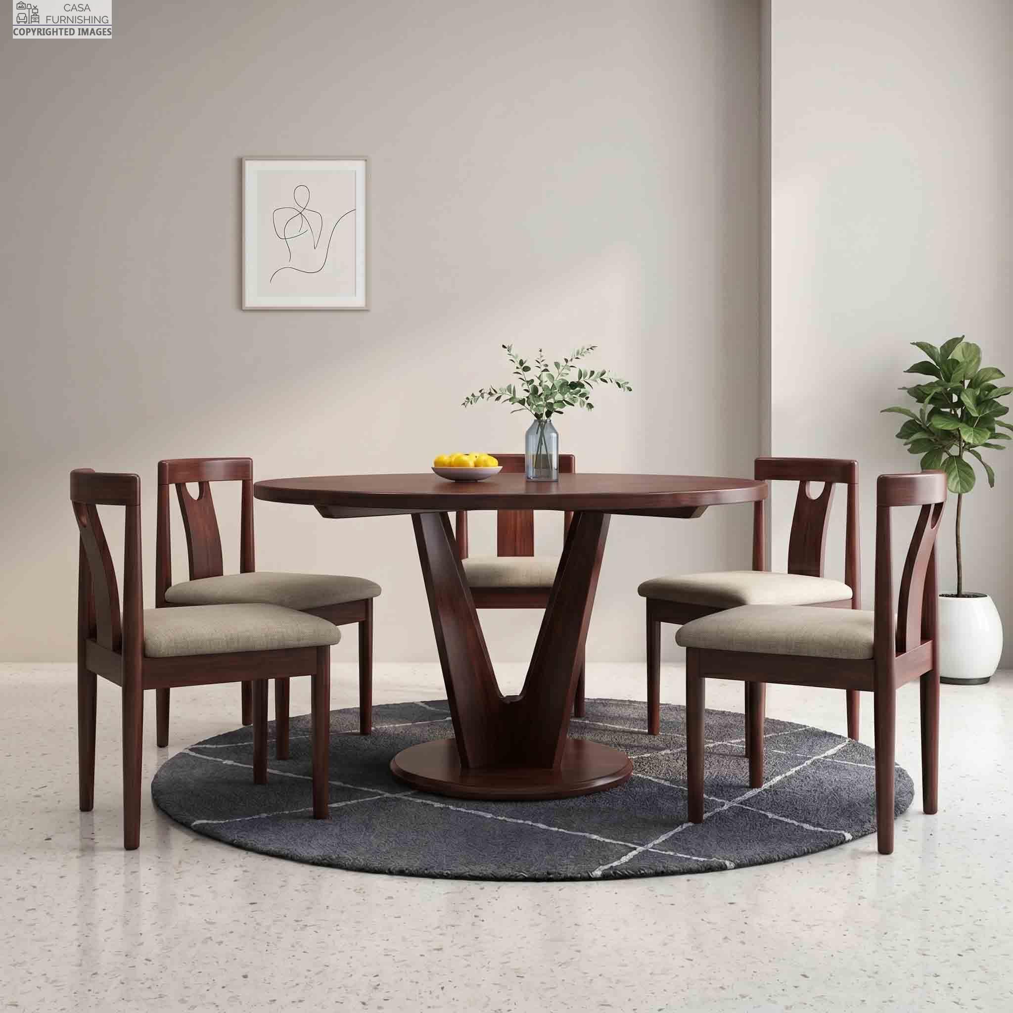 solid-sheesham-wood-round-4-seater-dining-table-set-with-cushioned-chairs Modern solid wood dining table featuring a unique geometric V-shaped pedestal base and four cream cushioned dining chairs.