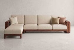 Front view of premium solid wood L-shaped sofa set featuring comfortable beige cushions and custom handmade wooden frame.
