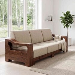 Casa Furnishing elegant 3 seater solid wood sofa featuring three divided beige fabric cushions and curved wooden armrests near a bright window.