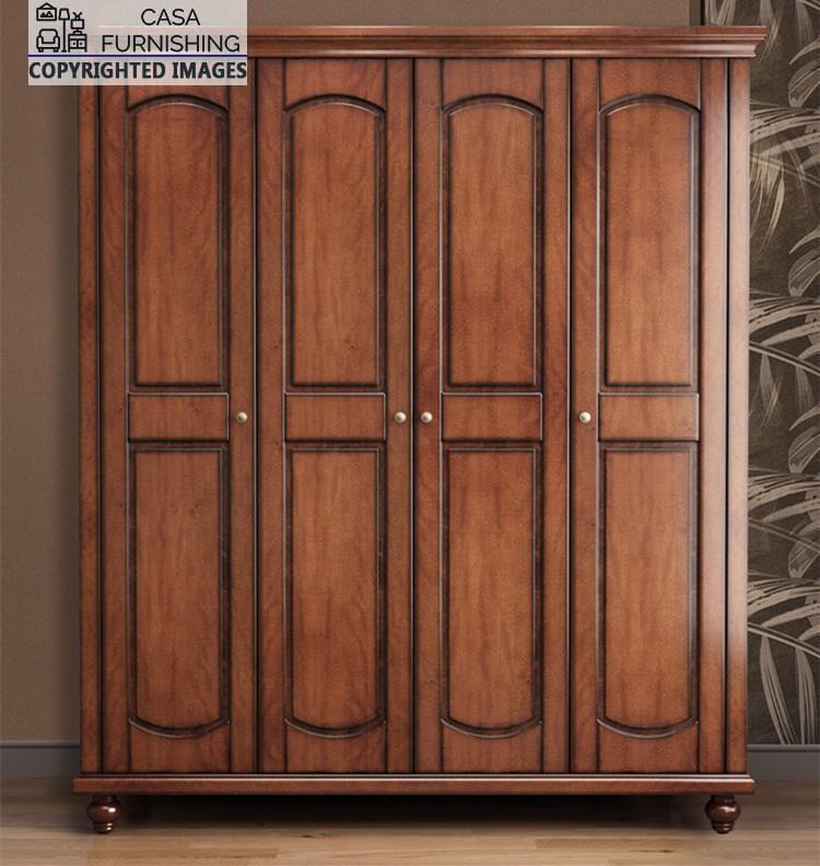 Four-Door-Wardrobe-2-1-1.jpg Straight front view of the closed freestanding 4-door wooden wardrobe by Casa Furnishing, featuring symmetrical arched panels, minimalist pull knobs, and classic bun feet.