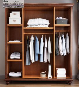 Full interior organizer layout of the open solid wood almirah, showcasing dual clothing hanging rods, multi-tier storage shelves with folded shirts, and dedicated compartments for organizer boxes.
