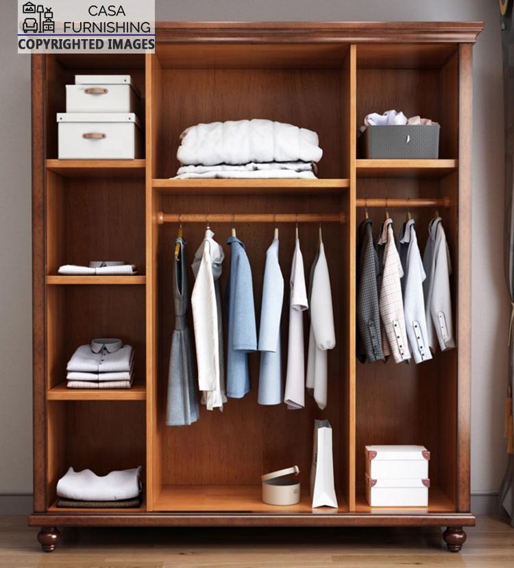 Four-Door-Wardrobe-3-1-1.jpg Full interior organizer layout of the open solid wood almirah, showcasing dual clothing hanging rods, multi-tier storage shelves with folded shirts, and dedicated compartments for organizer boxes.