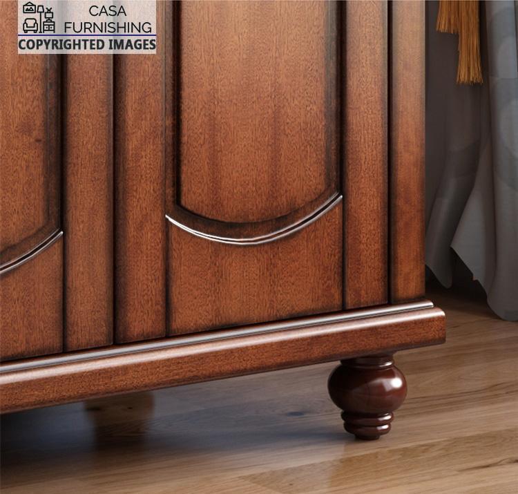 Four-Door-Wardrobe-4-1-1.jpg Close-up detail of the traditional wardrobe design craftsmanship, highlighting the elegant arched door panel groove accents and a beautifully turned bun foot.
