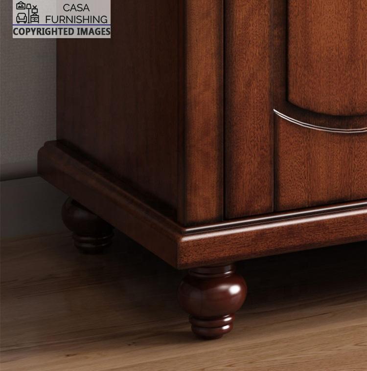 Four-Door-Wardrobe-5-1-1.jpg Detailed lower corner view of the premium solid wood wardrobe, highlighting the side profile depth, rich grain finish, and sturdy turned wooden feet layout.