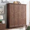 Angled view of the premium bedroom clothes closet, highlighting its rich matte brown finish, elegant wood grain textures, and decorative scalloped bottom apron in a modern bedroom setting.