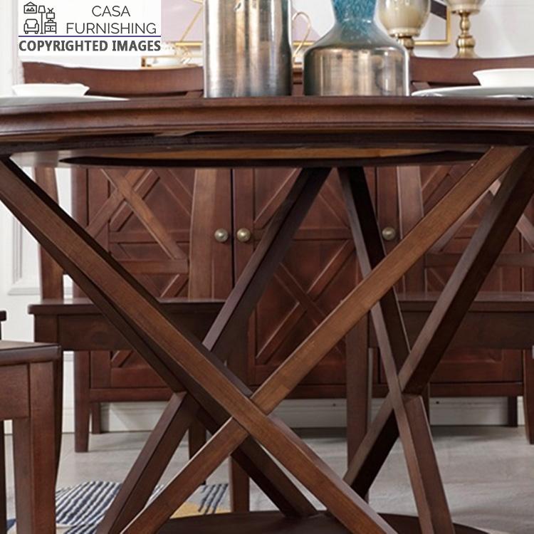 6-seater-round-dining-table-8-1-1-1.jpg Close-up of the unique geometric pedestal base of a handcrafted solid wood dining table in a dark walnut finish by Casa Furnishing.