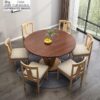 Elegant round solid wood dining room set from Casa Furnishing, showcasing a mahogany-toned tabletop and light wood frame. A space-saving 6-seater circular dining table for premium home decor.