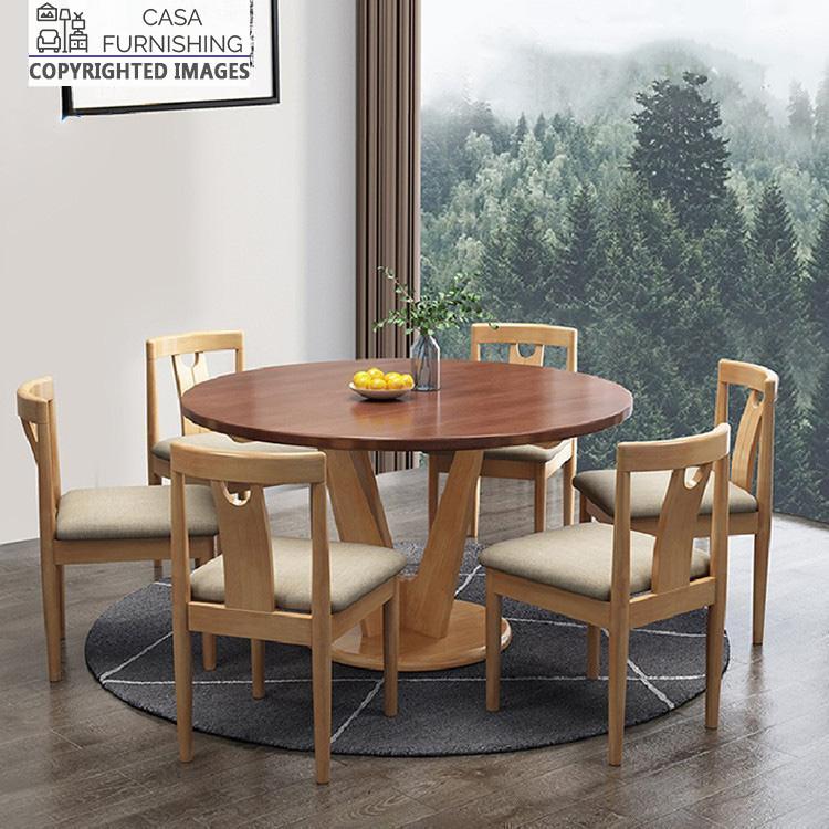 round-dining-table-6-seater-1-1-1.jpg Casa Furnishing round solid wood 6-seater dining table set with upholstered chairs. A handcrafted wooden furniture set featuring a two-tone finish, designed for contemporary dining room interiors.