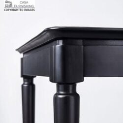 Close-up of a handcrafted black solid wood table corner by Casa Furnishing, showing premium joinery and a sleek matte finish. Durable and stylish wooden furniture for modern home decor.